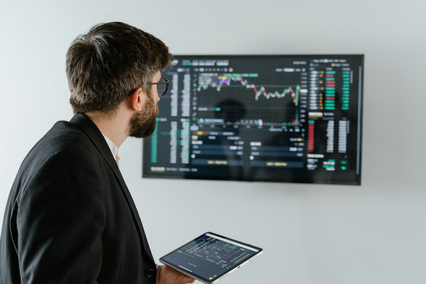 Financial analyst in a suit reviewing a market chart